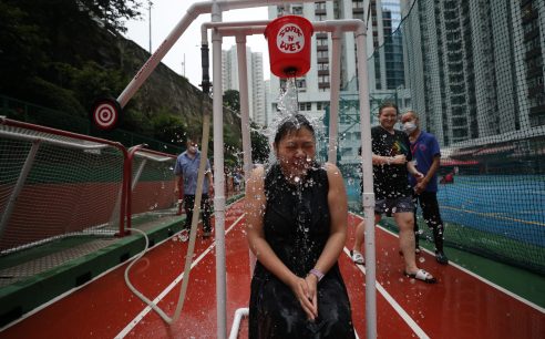SCMP 25NOV22 NS OSC Ms. Wanda Wong, a teacher of DSC International School of Canada in Tai Koo participates in Dunk Tank Challenge on the school campus, an OSC fund raising event. 25NOV22 SCMP / Xiaomei Chen